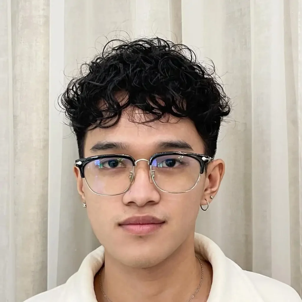 Modern Curly Undercut with Textured Top and Subtle Sideburns