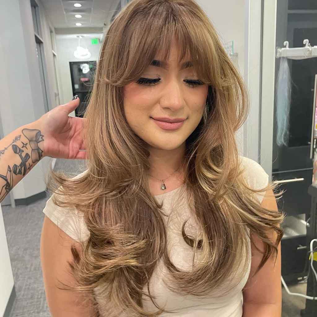Long Wavy Layered Bronde Hair With Curtain and Wispy Bangs