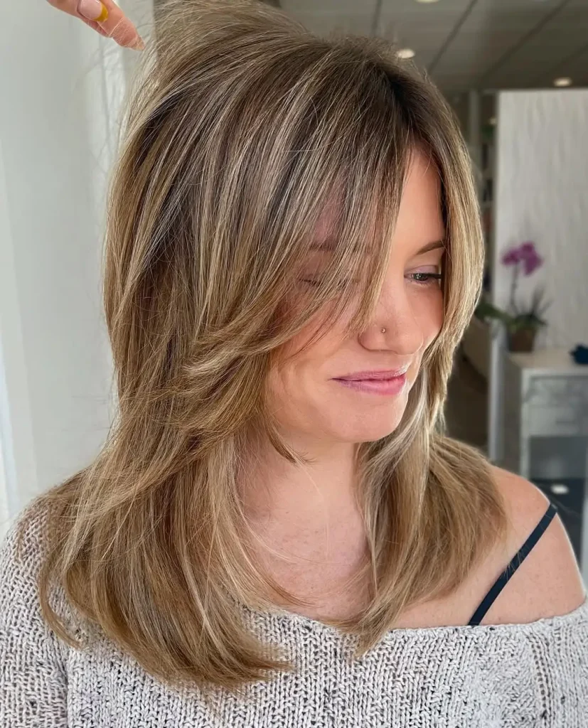13. Blonde Balayage Shaggy Wolf Cut With Bottleneck Bangs