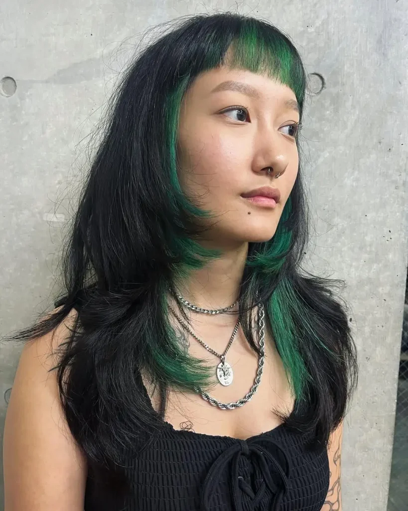 11. Long Wolf Cut With Deep Green Short Choppy Bangs and Highlights