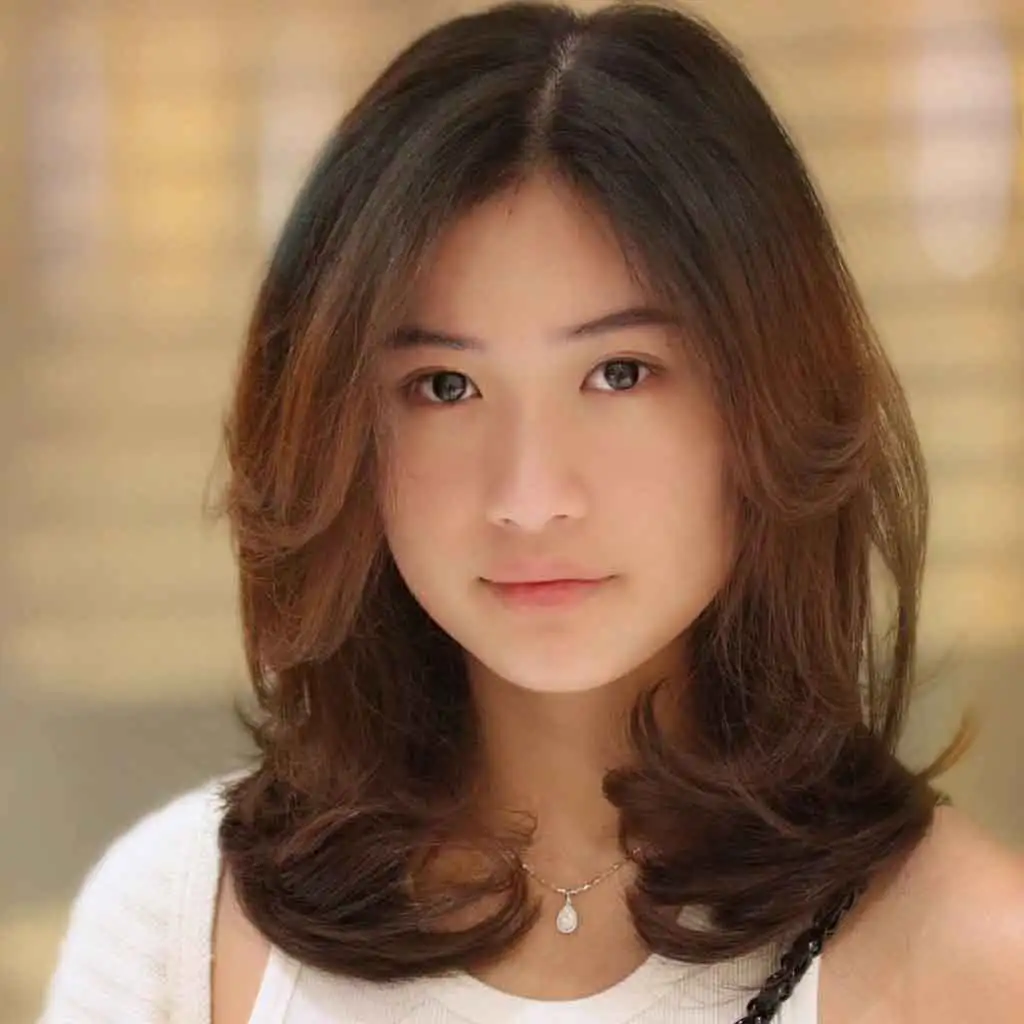 Medium Layered Haircut With Curtain Bangs