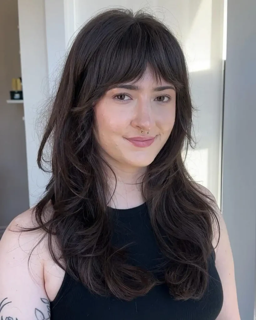 16. Long Black Wavy Wolf Cut With Extended Curtain Bangs