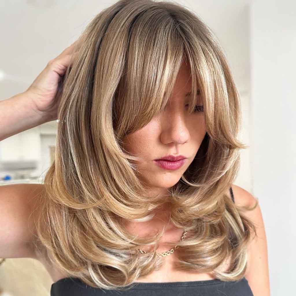 Face Framing Butterfly Cut on Blonde Hair With Curtain Bangs