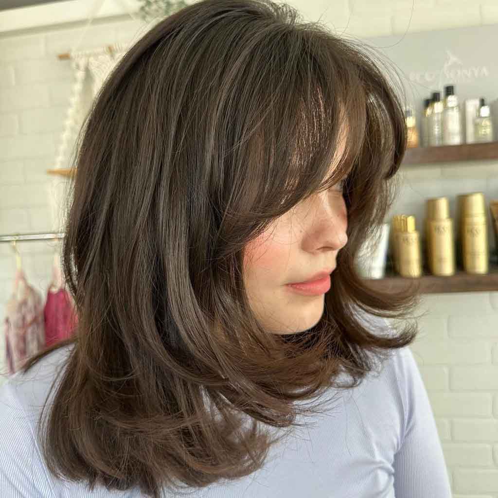 Medium Bouncy Layered Haircut With Curtain Bangs