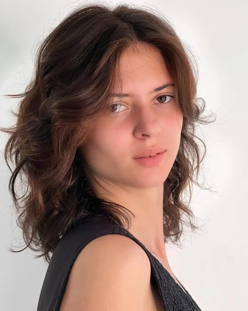 Medium Butterfly Cut Hairstyle with Soft Waves and Layers