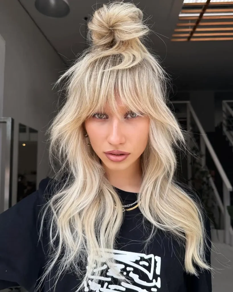 Long Shag Wolf Cut with Top Knot and Extended Bangs on Blonde Hair