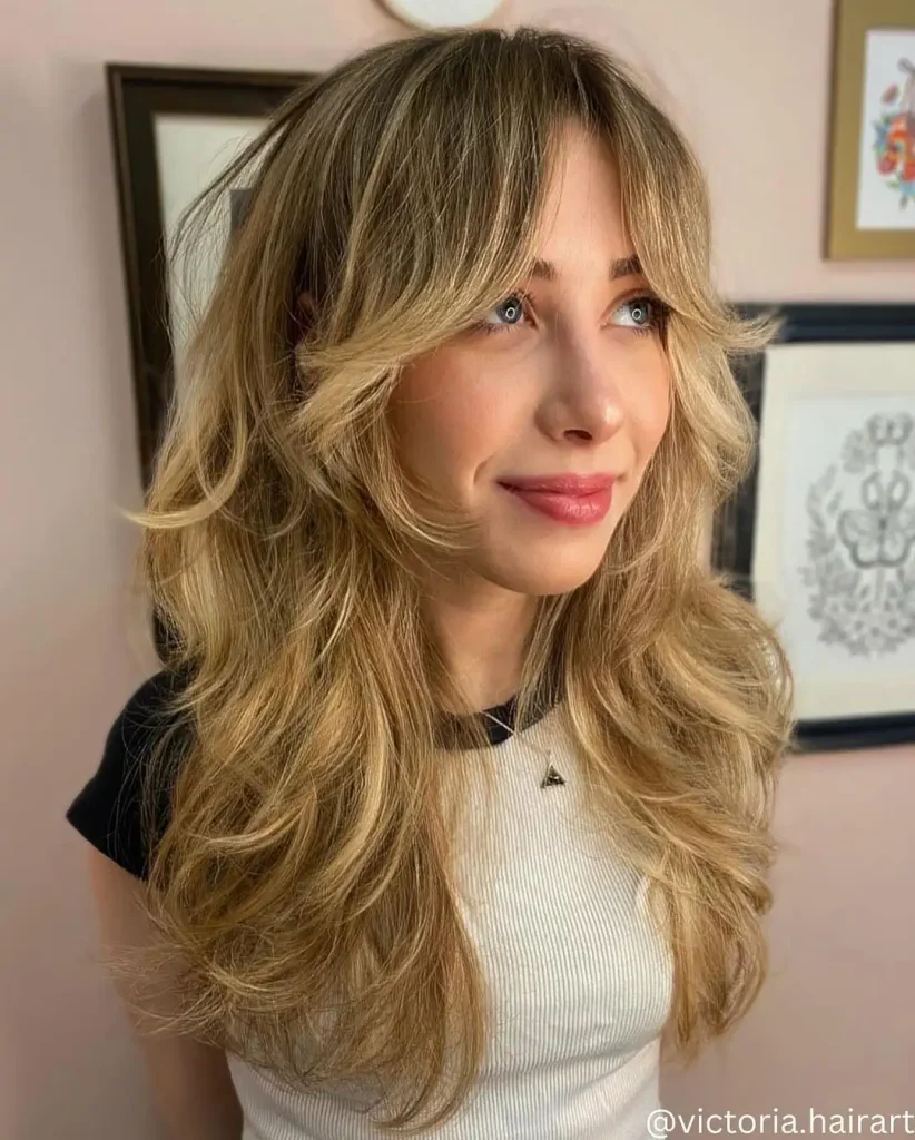 Long Blonde Wolf Cut with Highlighted Blunt Bangs and Wavy Ends