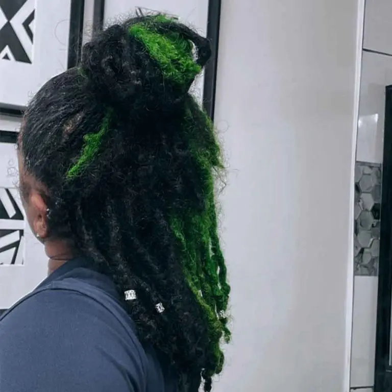 Green and Black Dreadlocks With Top Bun