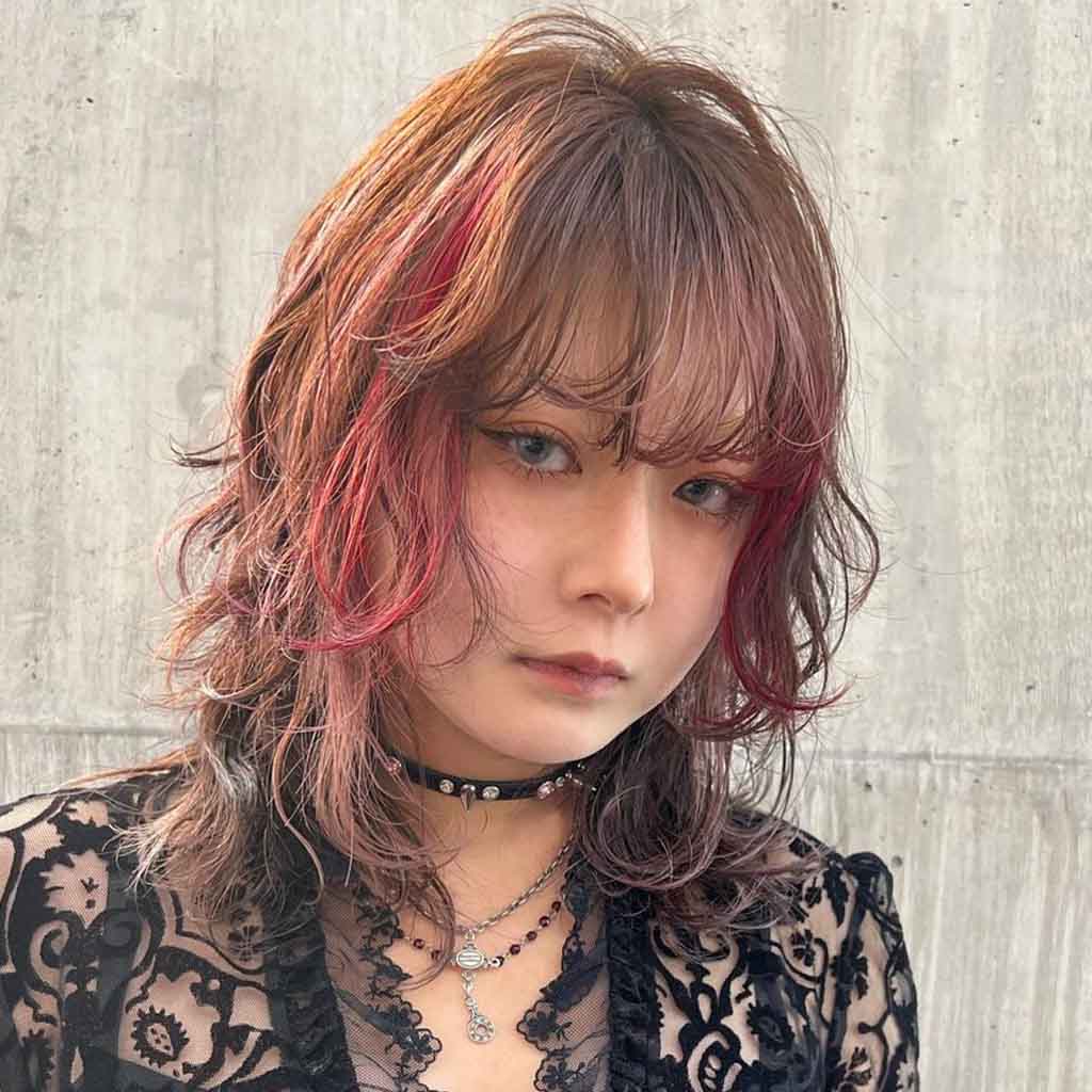 Brown Wolf Cut With Red Highlights and Extended Bangs