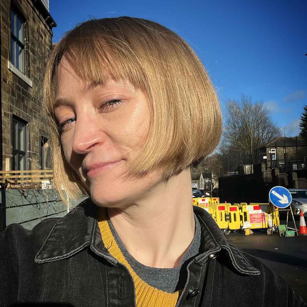 Jaw Length Blonde Razor Cut Bob With Curtain Bangs