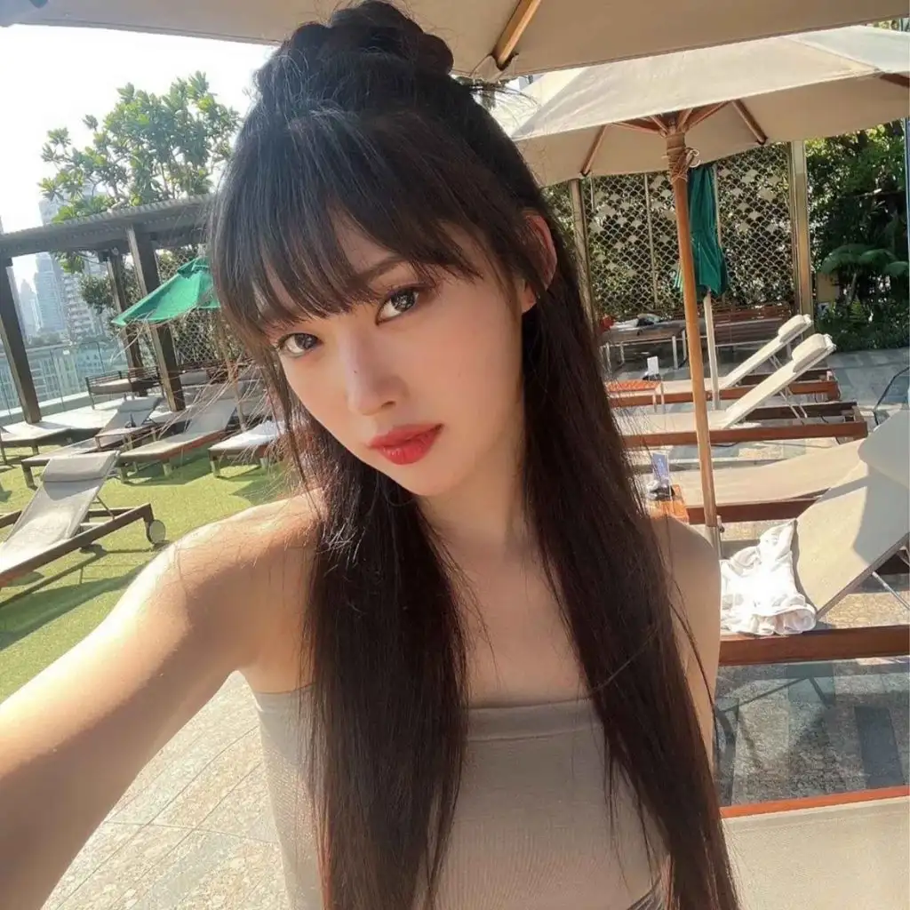 Long Straight Korean Hairstyle With Blunt Bangs and Bun