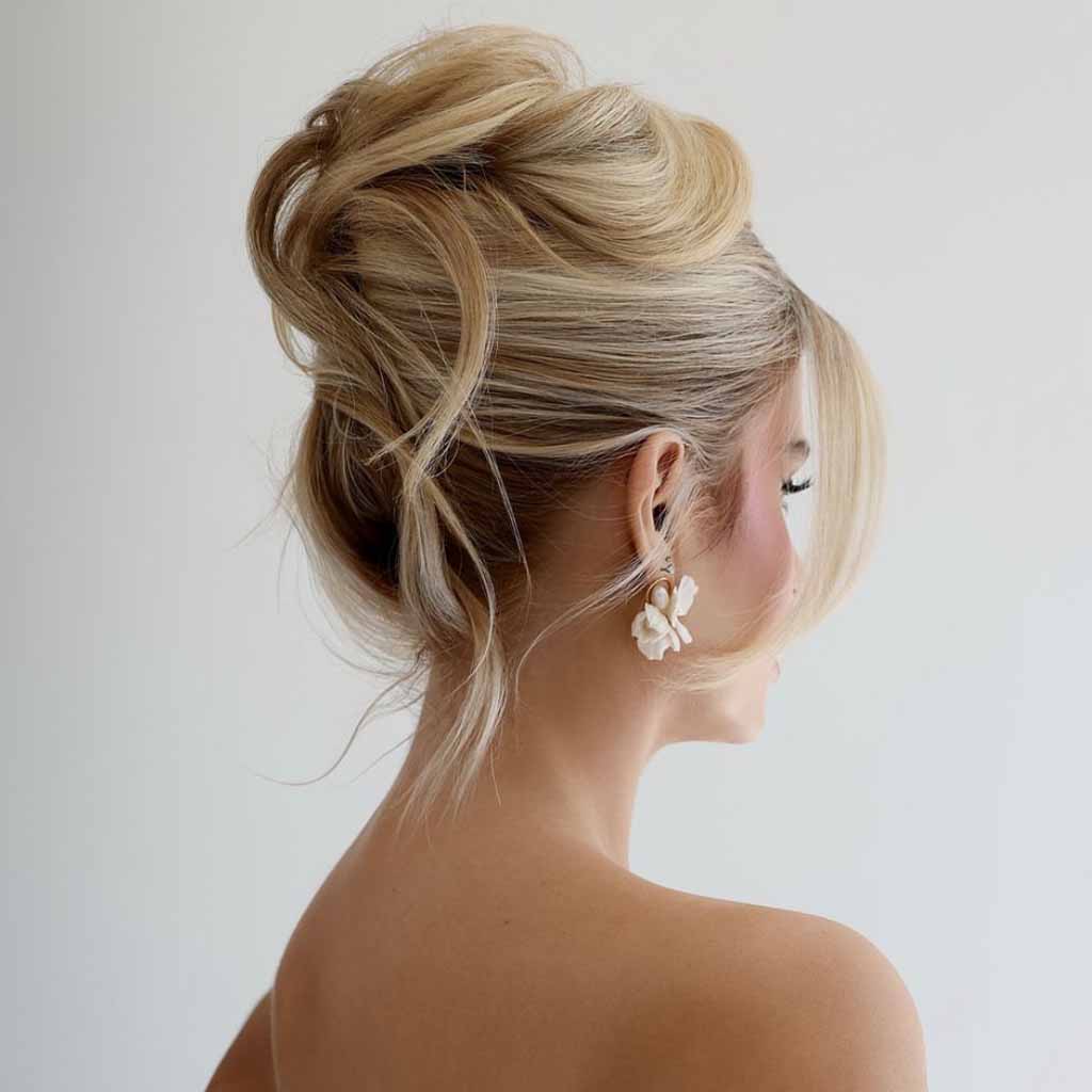 Blonde Messy Bun Updo With Face-Framing Tendrils