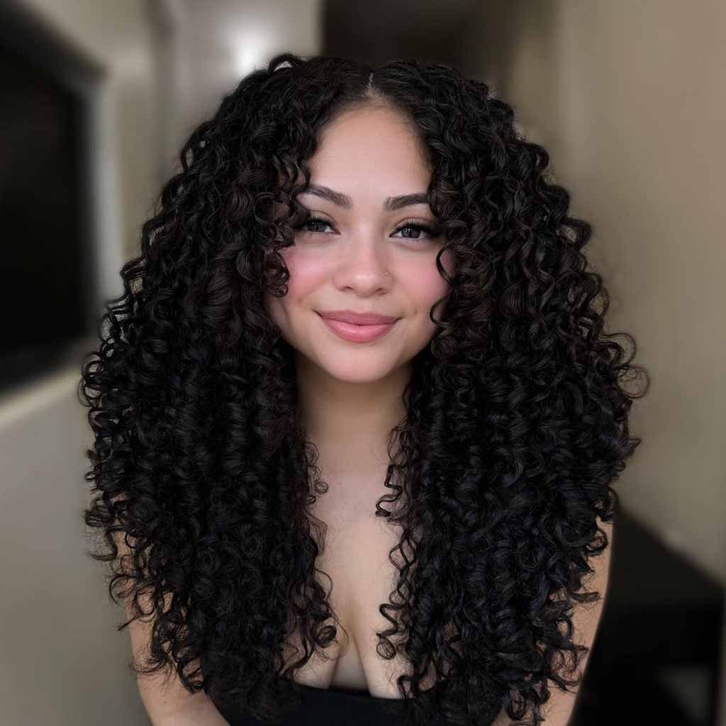 Long Black Coiled Curls With Face-Framing Layers