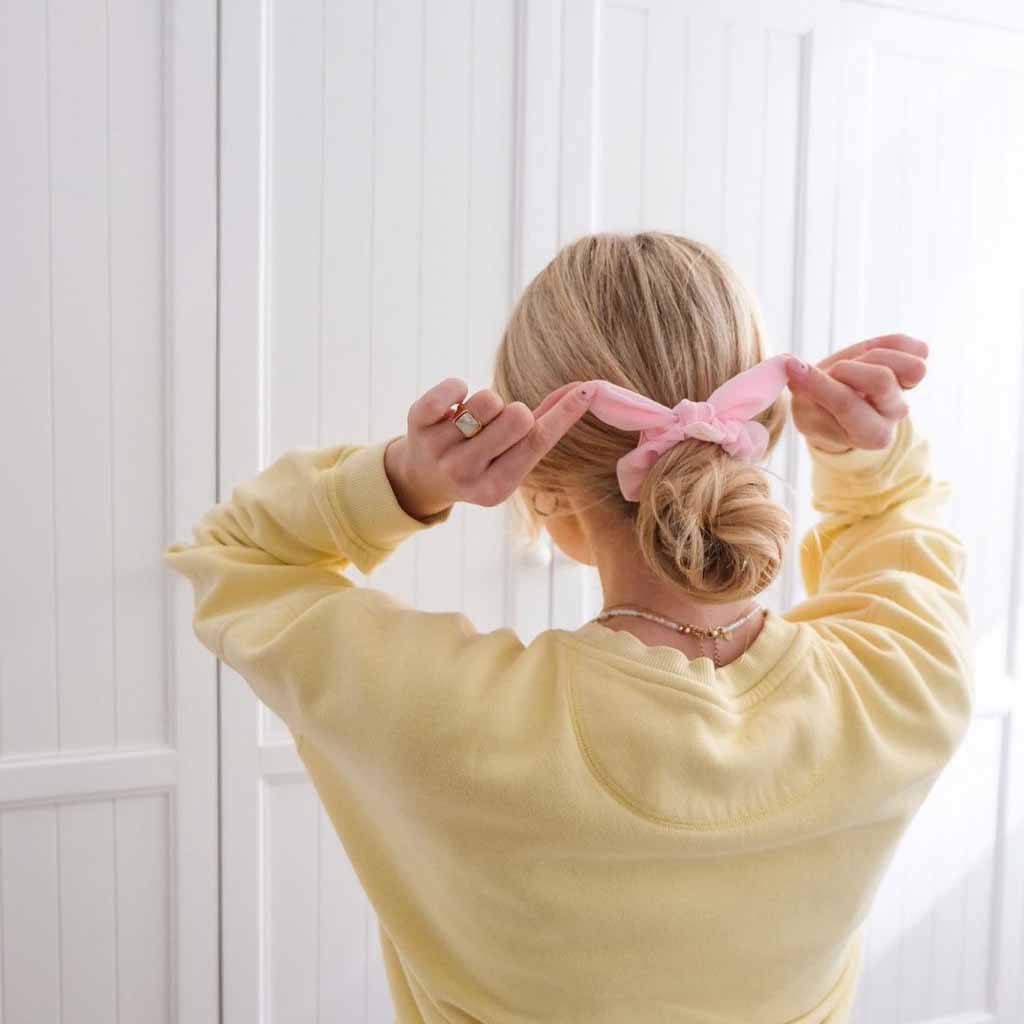 Low Tousled Bun Styled With a Bow Scrunchie
