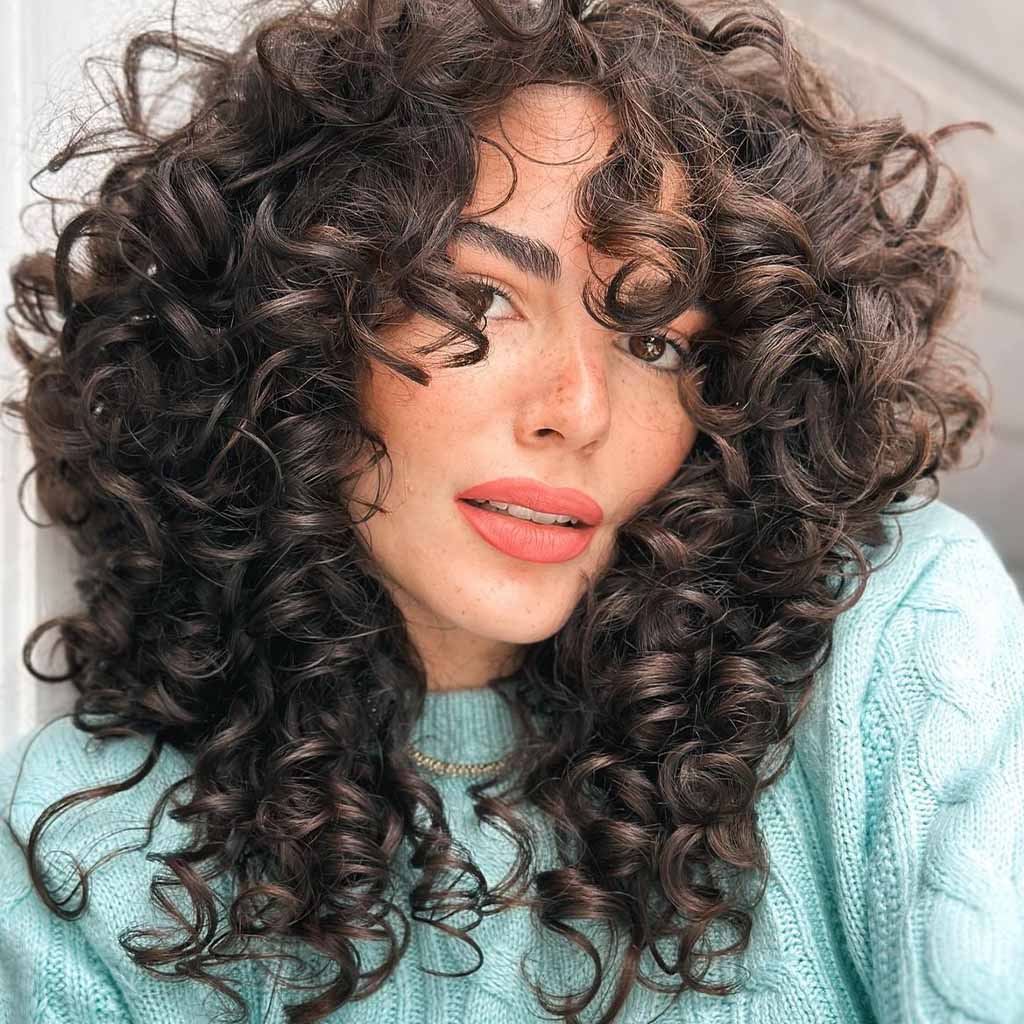 Tousled Layered Curly Medium Hair With Brown Highlights