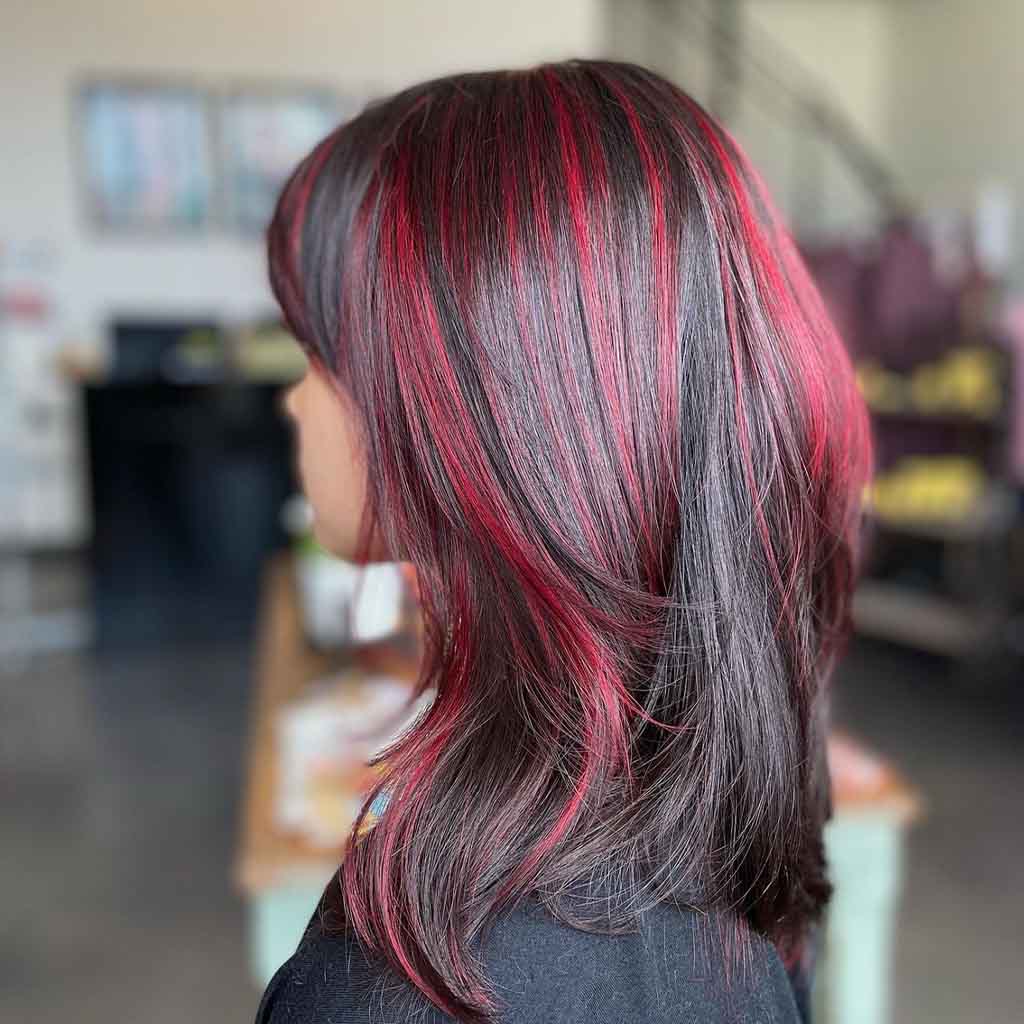 Cherry Bomb Highlights on Black Layered Hair With Bangs