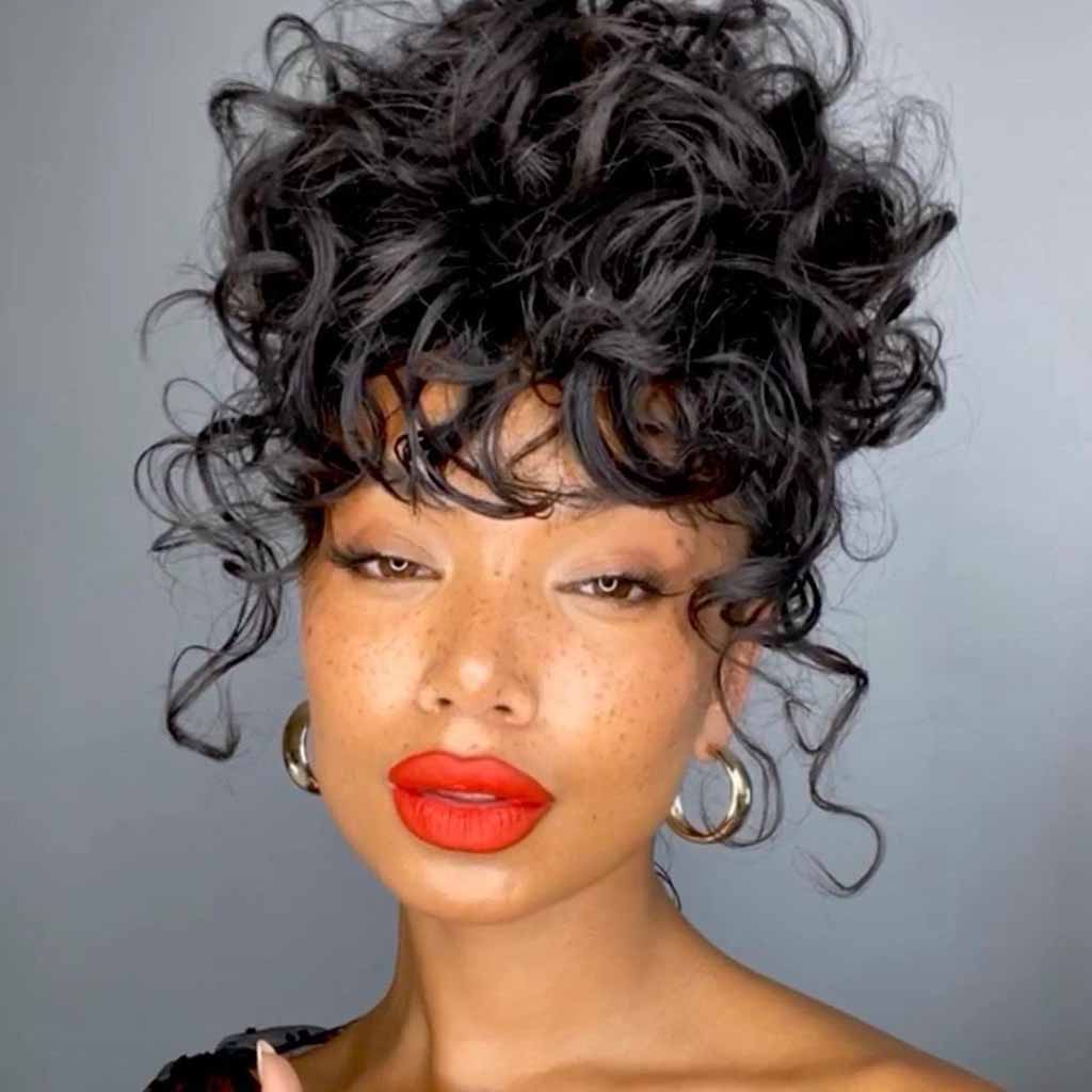 Medium Curly Messy Bun WIth Curly Bangs
