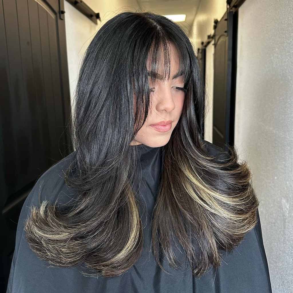 Wispy Bangs With Face Framing and Black Long Layered Hair With Blonde Highlights