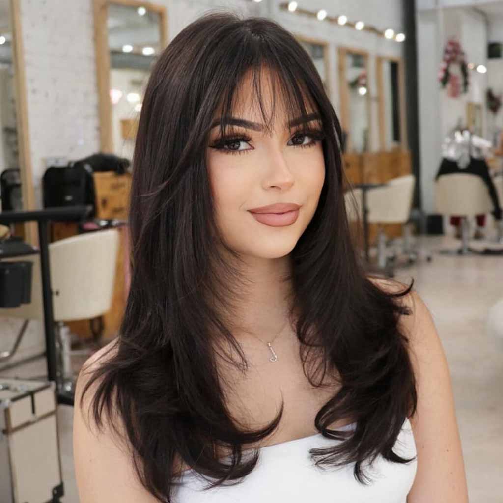 Layered Haircut on Long Black Hair With Wispy Bangs