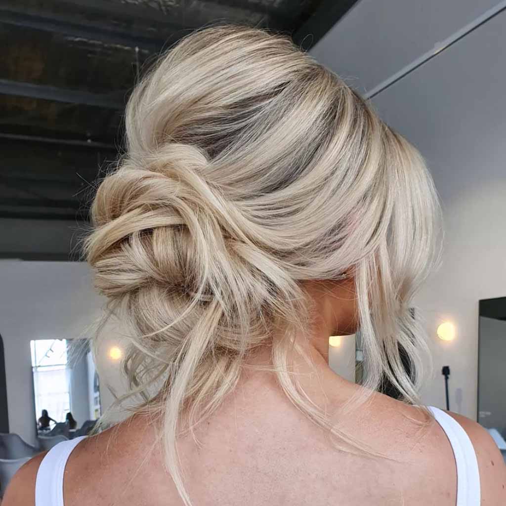 Wavy Messy Blonde Bouffant Bun With TendrilsWavy Messy Blonde Bouffant Bun