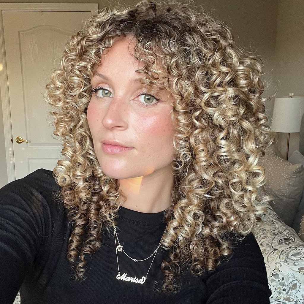 Blonde Spiral Curls With Curly Curtain Bangs and Brown Highlights