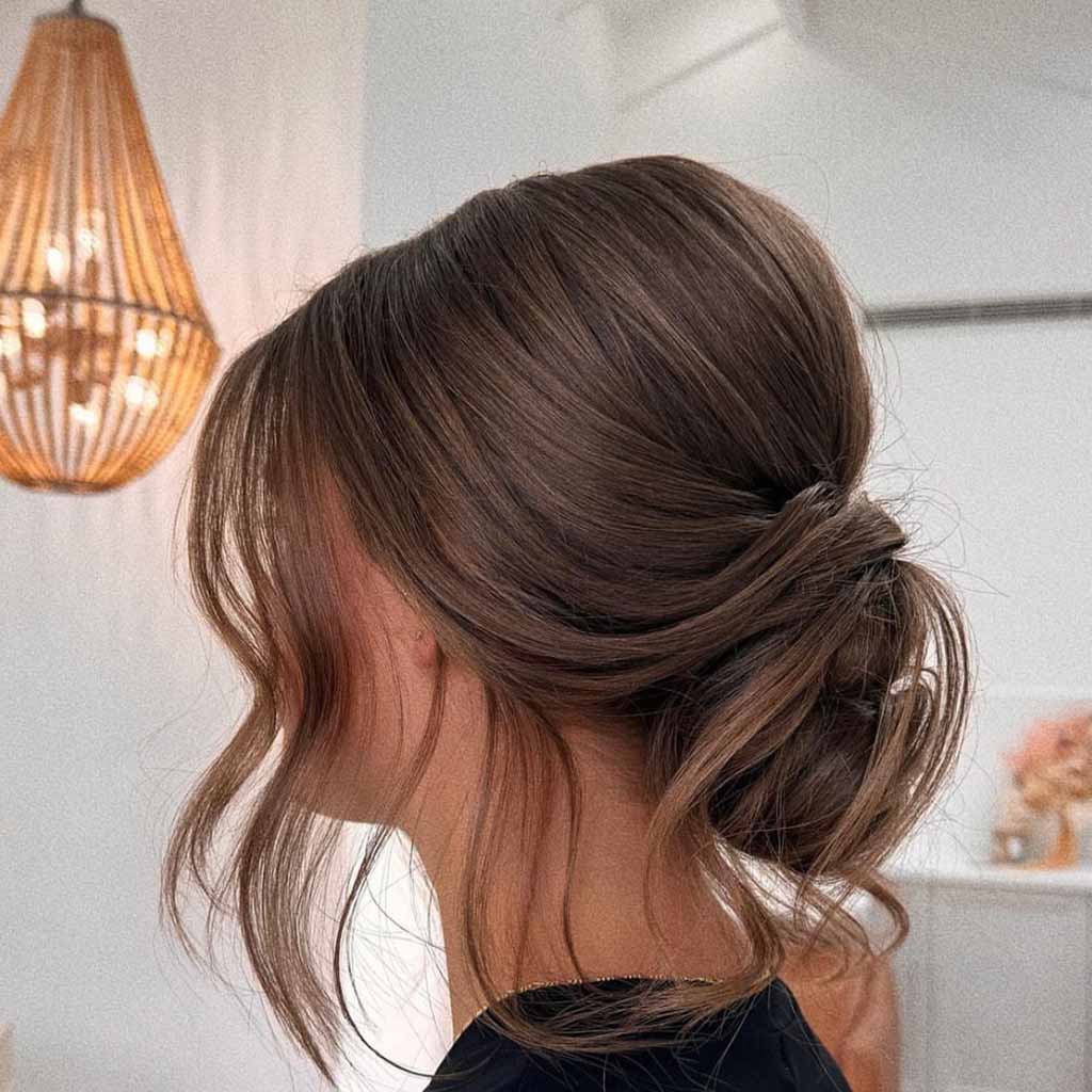 Tucked Chignon With Wavy Tendrils