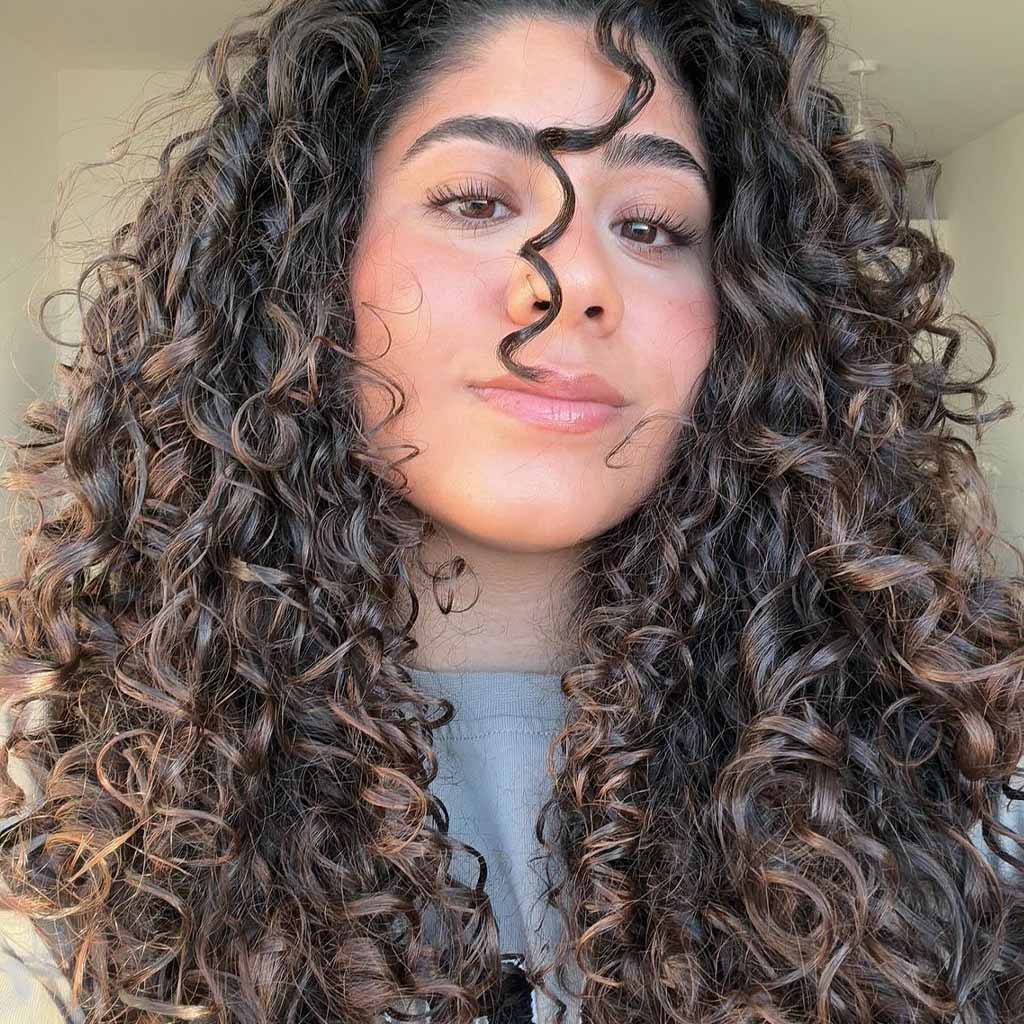 Long Voluminous Bouncy Curls With Brown Balayage