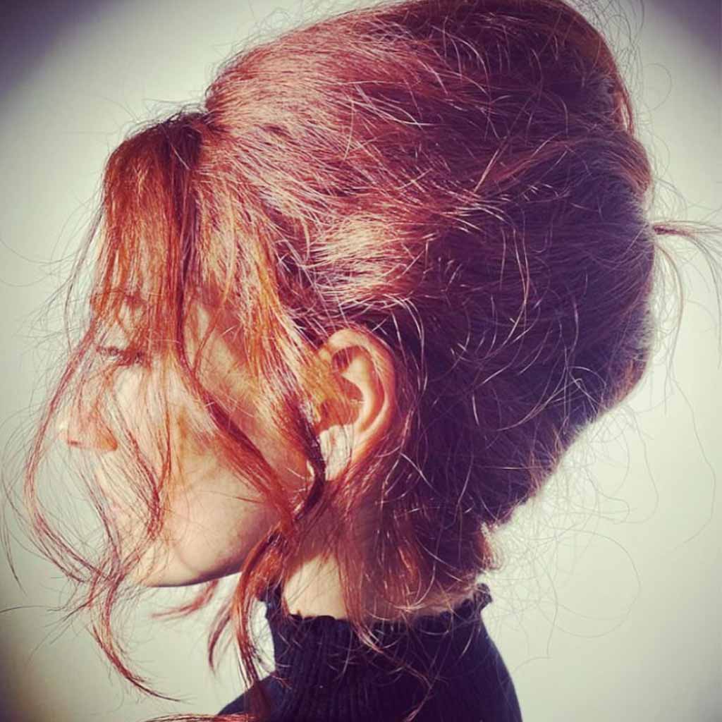 Tousled Red Beehive Hairstyle With Tendrils