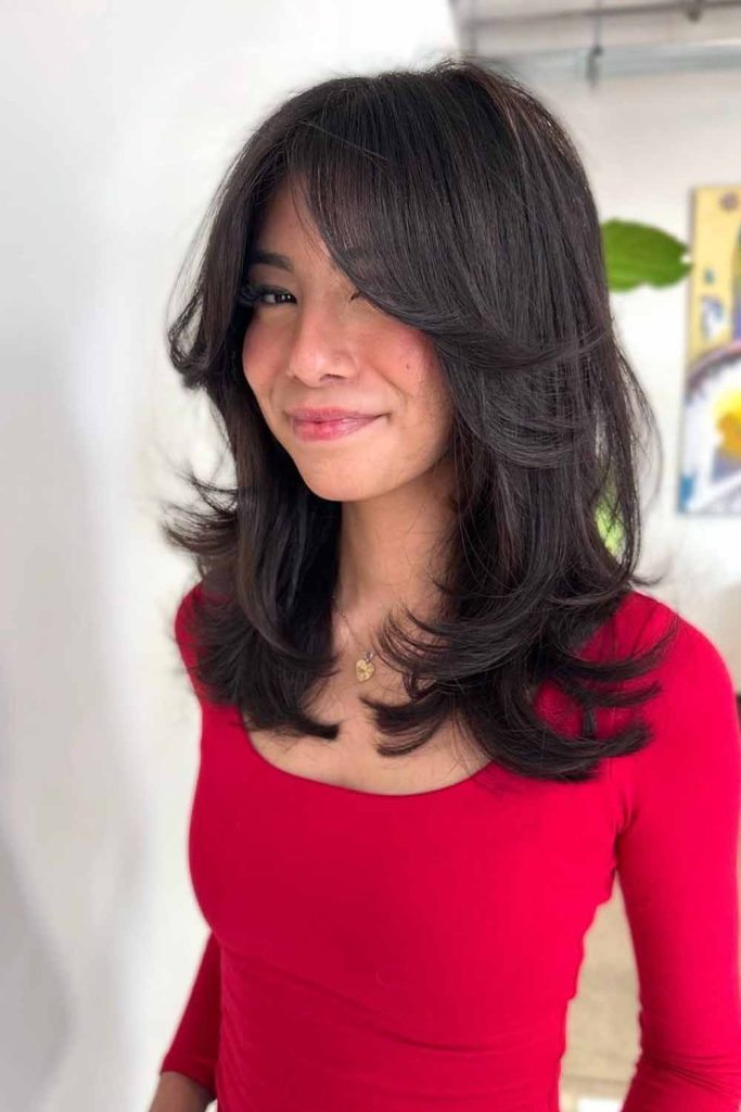 Mid Length Hair With Face-Framing Layers and Curtain Bangs
