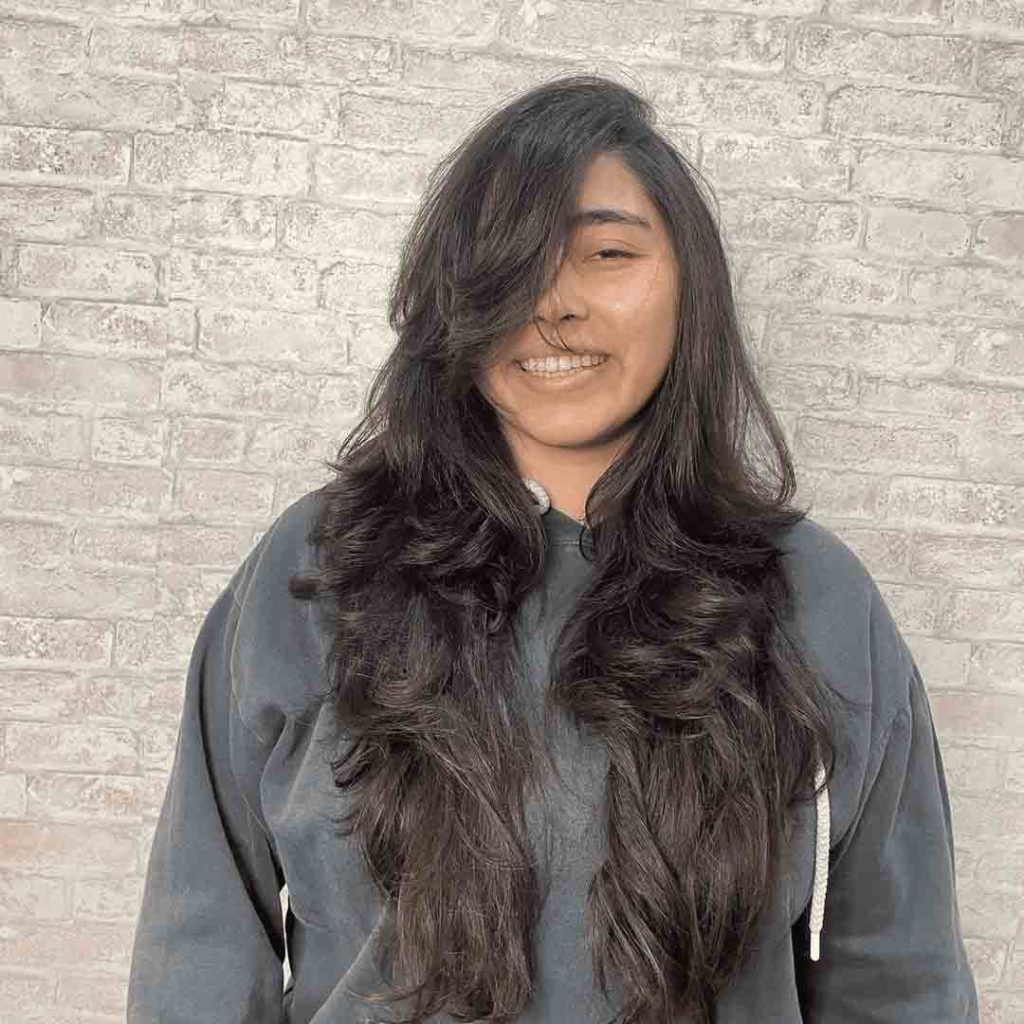 Long Wavy Hair With Wolf Cut and Side-Swept Bangs