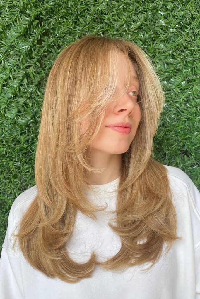 Butterfly Cut on Blonde Hair with Layered Bangs