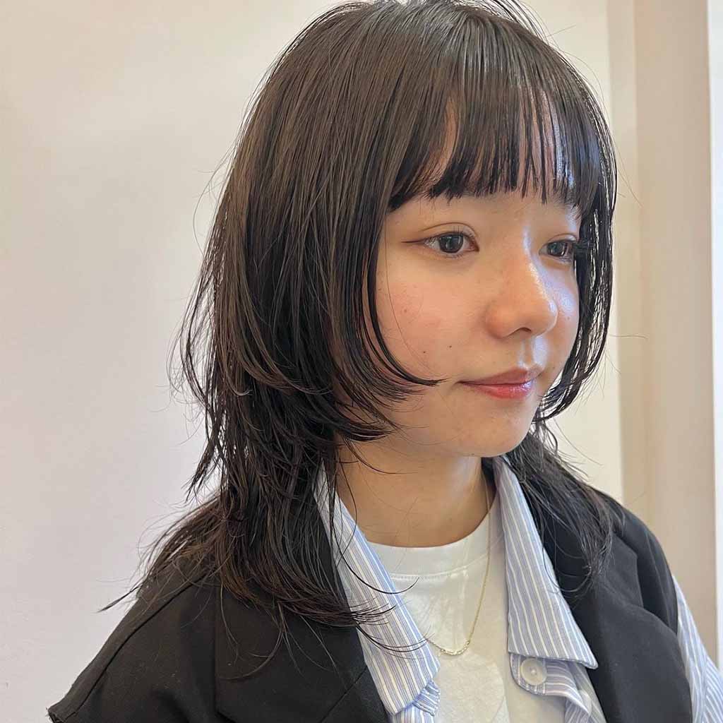 Medium Length Wolf Cut With Face Layers and Choppy Bangs
