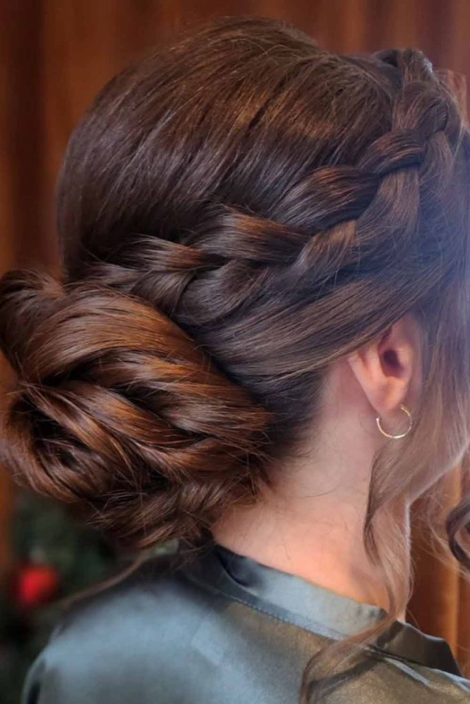 Low Plaited Brunette Bun With Wavy Tendrils