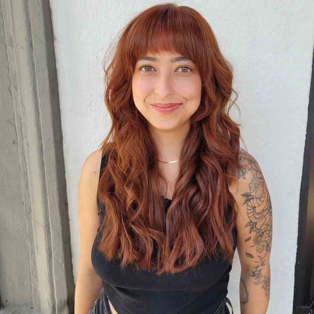 Shag Cut for Wavy Ginger Hair With Curved Bangs
