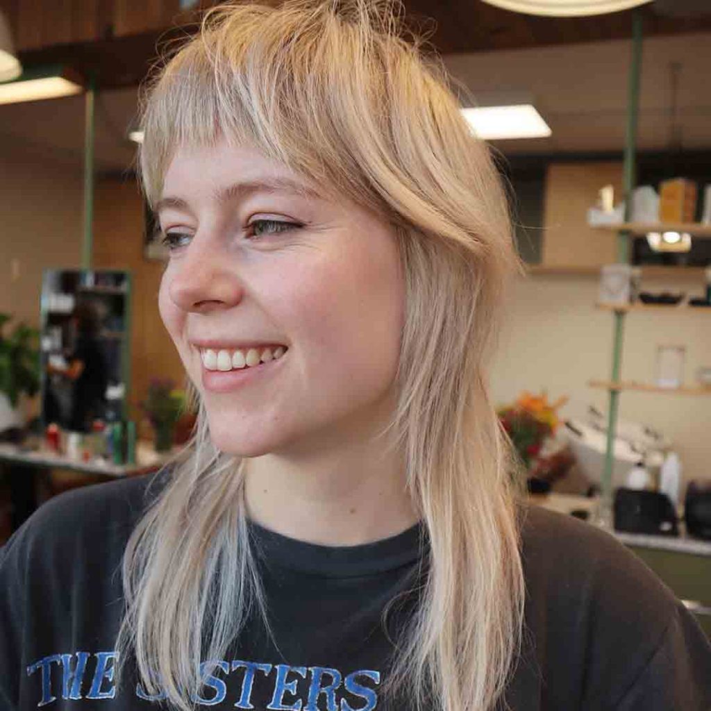 Blonde Shag Mullet Haircut With Curved Choppy Bangs