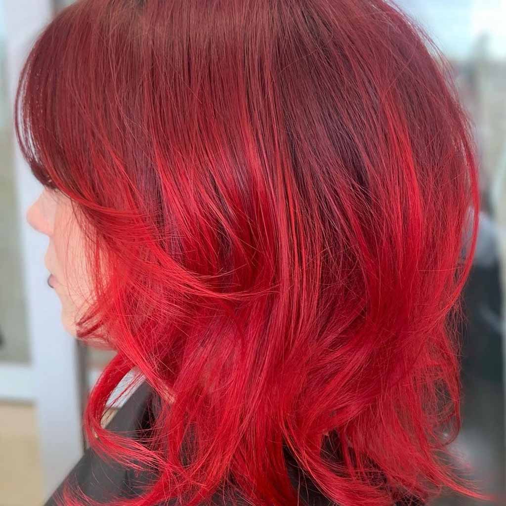 Short Fluffy Wolf Cut With Bright Red Highlights